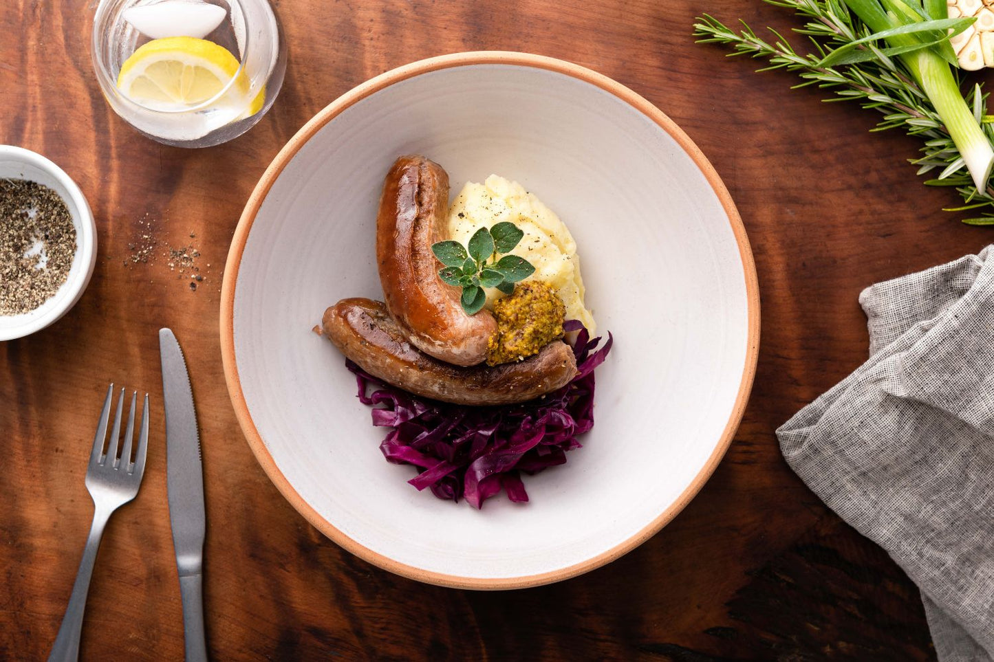 Pork sausages, mustard potato mash, braised red cabbage