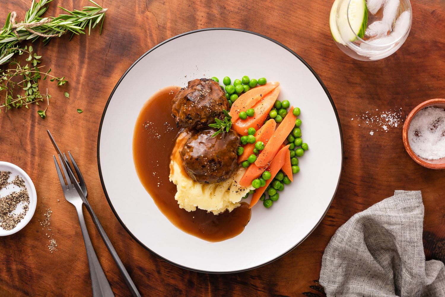 Beef rissoles with mash, carrots and peas